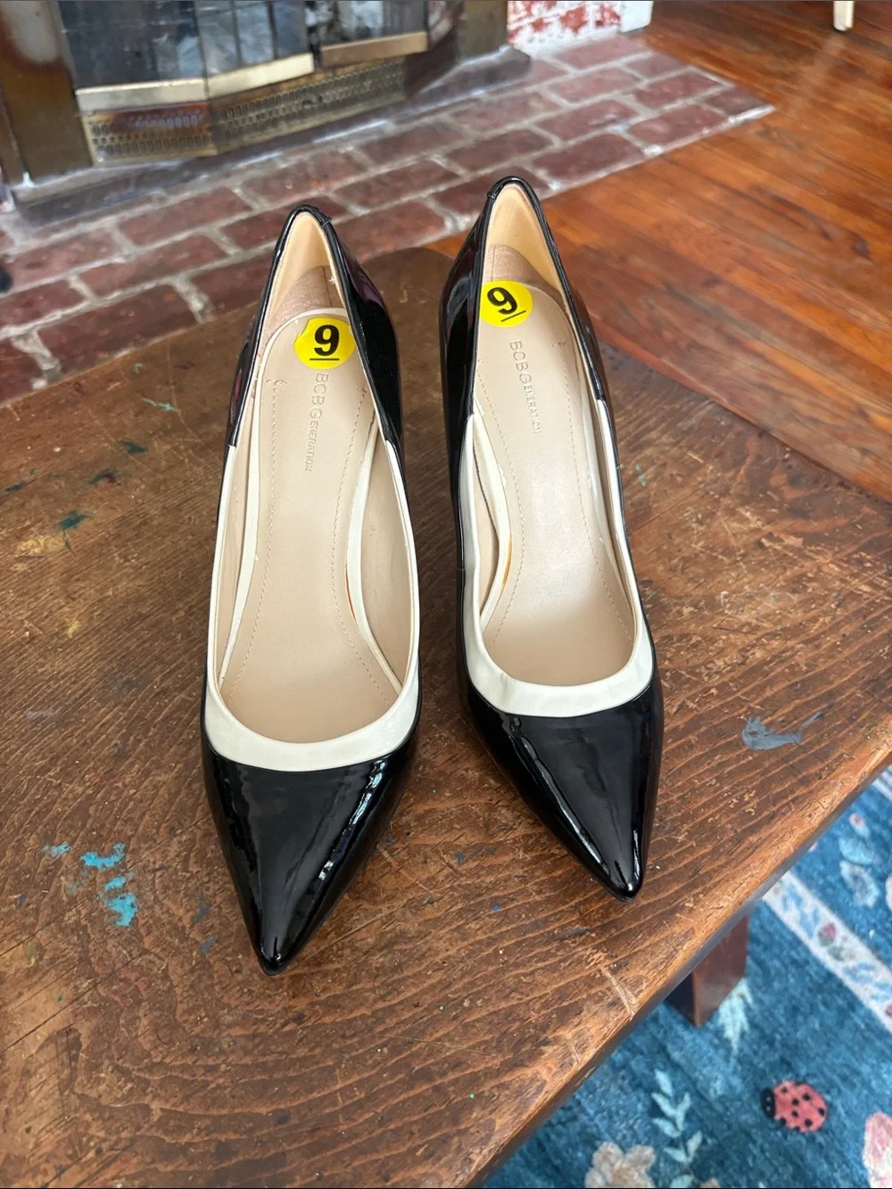 BCBGeneration Black Patent Pointed-Toe Pumps with Cream Trim